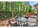 Relaxing backyard setting with wood deck, table and chairs, and forest-like views at 201 Dunhagan Pl, Cary, NC 27511