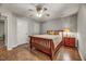Relaxing bedroom featuring hardwood floors, a ceiling fan, and neutral colored walls at 201 Dunhagan Pl, Cary, NC 27511