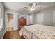 Comfortable bedroom featuring hardwood floors, a dresser with a tv, and an en-suite bathroom at 201 Dunhagan Pl, Cary, NC 27511