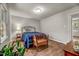 Bright bedroom showcasing a window overlooking the yard and hardwood floors at 201 Dunhagan Pl, Cary, NC 27511