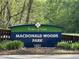 MacDonald Woods Park signage surrounded by lush greenery creates a welcoming outdoor community space at 201 Dunhagan Pl, Cary, NC 27511
