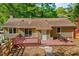 Cozy single-story home with a charming wooden deck and outdoor seating area at 201 Dunhagan Pl, Cary, NC 27511