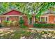 Attractive brick home with cozy front porch and lush landscaping at 201 Dunhagan Pl, Cary, NC 27511