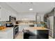 Beautiful kitchen with white cabinetry, stainless appliances, and decorative tile backsplash at 201 Dunhagan Pl, Cary, NC 27511