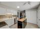 Charming kitchen featuring stainless steel appliances, a mosaic backsplash, and a functional kitchen island at 201 Dunhagan Pl, Cary, NC 27511