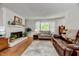 Bright living room with fireplace, hardwood floors, and a comfortable seating area at 201 Dunhagan Pl, Cary, NC 27511