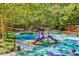 Charming playground with slides, swings, and lush green surroundings offers a fun outdoor space at 201 Dunhagan Pl, Cary, NC 27511