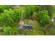 Aerial view of home and property with circular driveway and lots of trees at 2024 Country Trails Dr, Clayton, NC 27520