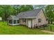 Backyard featuring green grass, vinyl siding, and an enclosed porch at 2024 Country Trails Dr, Clayton, NC 27520