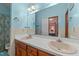 Bathroom with a double sink vanity, white countertop, and a large mirror at 2024 Country Trails Dr, Clayton, NC 27520