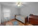 Cozy bedroom featuring hardwood floors, a ceiling fan, and a vintage wooden dresser at 2024 Country Trails Dr, Clayton, NC 27520