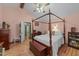 Vaulted bedroom featuring a four-poster bed, hardwood floors, and a walk-in closet at 2024 Country Trails Dr, Clayton, NC 27520