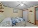 Bedroom featuring a single bed with quilt, closet, and yellow walls with decorative wallpaper at 2024 Country Trails Dr, Clayton, NC 27520