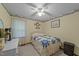 Cozy bedroom with a single bed, patterned quilt, ceiling fan, and light yellow walls at 2024 Country Trails Dr, Clayton, NC 27520