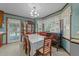 Bright dining area featuring a chandelier, tile flooring, and traditional wood furniture at 2024 Country Trails Dr, Clayton, NC 27520
