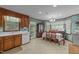 Bright dining area featuring a chandelier, tile flooring, and traditional wood furniture at 2024 Country Trails Dr, Clayton, NC 27520