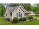 Exterior showcasing lush greenery, manicured lawn, and well-maintained home at 2024 Country Trails Dr, Clayton, NC 27520