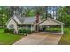 Charming home featuring a cozy front porch, well-manicured landscaping, and a convenient carport at 2024 Country Trails Dr, Clayton, NC 27520