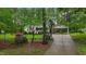 Charming home surrounded by blooming trees and lush landscaping; a serene curb appeal at 2024 Country Trails Dr, Clayton, NC 27520