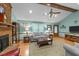 Inviting living room with a brick fireplace, ceiling fan, and a comfortable seating area at 2024 Country Trails Dr, Clayton, NC 27520