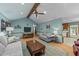 Spacious living room with a vaulted ceiling, brick fireplace, and laminate wood flooring at 2024 Country Trails Dr, Clayton, NC 27520