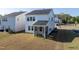A spacious backyard featuring a covered patio area on a modernly built home at 205 Fig Tree Bnd, Zebulon, NC 27597