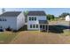 View of the backyard with a covered patio area on a modern two-story home at 205 Fig Tree Bnd, Zebulon, NC 27597