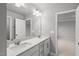 Bathroom with double sink vanity, modern lighting, and a neutral color scheme at 205 Fig Tree Bnd, Zebulon, NC 27597