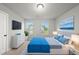 Well-lit bedroom boasting a large bed, neutral walls, and a mounted television for entertainment at 205 Fig Tree Bnd, Zebulon, NC 27597