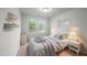Bright bedroom featuring neutral walls, carpet flooring, and natural light from dual windows at 205 Fig Tree Bnd, Zebulon, NC 27597