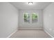 Serene bedroom offering soft carpet, natural light from two windows, and ample open space at 205 Fig Tree Bnd, Zebulon, NC 27597