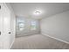 Inviting bedroom featuring natural light, neutral walls, and a door leading to another room at 205 Fig Tree Bnd, Zebulon, NC 27597
