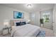 Comfortable bedroom with a plush bed, stylish decor, and calming ambiance from natural light at 205 Fig Tree Bnd, Zebulon, NC 27597
