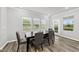 Dining area features a dark table, four chairs and views of the backyard at 205 Fig Tree Bnd, Zebulon, NC 27597