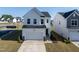 Charming white two-story home with a two-car garage and well-maintained landscaping at 205 Fig Tree Bnd, Zebulon, NC 27597
