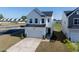 Charming two-story home featuring a two-car garage, modern facade and well-manicured lawn at 205 Fig Tree Bnd, Zebulon, NC 27597