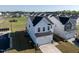 Home in neighborhood with lush green space, community playground, and attached two car garage at 205 Fig Tree Bnd, Zebulon, NC 27597