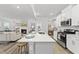 Modern kitchen featuring a large island with seating and views into the living room at 205 Fig Tree Bnd, Zebulon, NC 27597
