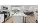 Modern kitchen with stainless steel appliances and a large island with seating at 205 Fig Tree Bnd, Zebulon, NC 27597