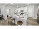 Bright kitchen featuring a large island with seating, stainless appliances, and modern finishes at 205 Fig Tree Bnd, Zebulon, NC 27597
