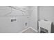Practical laundry room complete with utility sink, storage shelves, and necessary hookups at 205 Fig Tree Bnd, Zebulon, NC 27597