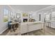 Cozy living room with fireplace, light-colored walls, wood floors, and large windows at 205 Fig Tree Bnd, Zebulon, NC 27597