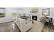 Open living room features a fireplace and a large window with backyard views at 205 Fig Tree Bnd, Zebulon, NC 27597