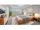 Spacious main bedroom featuring large bed, tray ceilings, three windows, and dresser at 205 Fig Tree Bnd, Zebulon, NC 27597