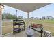 A screened-in patio with outdoor furniture overlooks a grassy area at 205 Fig Tree Bnd, Zebulon, NC 27597