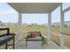 View from screened-in patio towards grassy area with playground and other homes at 205 Fig Tree Bnd, Zebulon, NC 27597