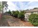 Large backyard with a patio seating area, lush greenery, retaining walls, and privacy fencing at 2109 Hemlock Hill Dr, Durham, NC 27703