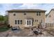 The backyard features a stone patio with outdoor furniture, a grill, and manicured landscaping for relaxing and entertaining at 2109 Hemlock Hill Dr, Durham, NC 27703