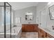 Bright bathroom features a soaking tub and marble countertop vanity with updated fixtures and hardware at 2109 Hemlock Hill Dr, Durham, NC 27703