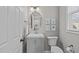 This charming powder room features a modern vanity, oval mirror, and tasteful wall decor at 2109 Hemlock Hill Dr, Durham, NC 27703